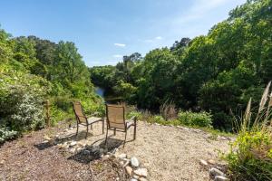 two chairs sitting on a hill overlooking a river at 3021 - Southern Snores in Kitty Hawk Beach