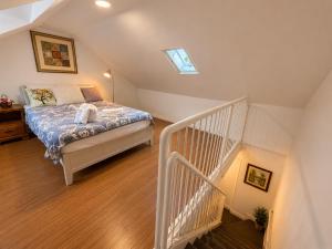 a bedroom with a bed and a staircase at ChinaTown Boutique Rooms in Toronto +9 photos