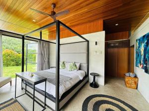 a bedroom with a bed and a ceiling fan at Laman Villa Port Dickson in Port Dickson +55 photos