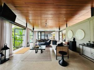 a living room with a couch and a table at Laman Villa Port Dickson in Port Dickson
