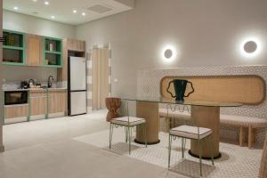 a kitchen with a table and two chairs at Good Days Caesar in Ras Elhekma