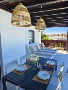 a dining room with a black table and chairs at Villas Rodríguez in Playa Blanca +37 photos