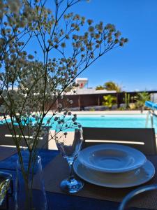 a table with a plate on a table with a pool at Villas Rodríguez in Playa Blanca