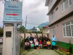a group of people standing in front of a building at Basera Residency Shalimar in Bāgh Chandpura