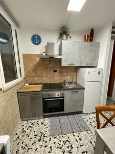 a kitchen with a sink and a stove and refrigerator at Al Duca 165 in Ladispoli