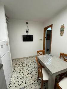 a kitchen with a table and chairs and a refrigerator at Al Duca 165 in Ladispoli +12 photos