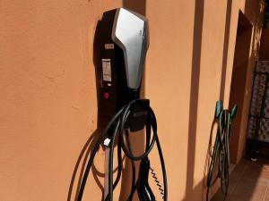 a pay phone is hooked up to a wall at Patios do Algarve in Ferragudo +9 photos