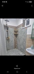a bathroom with a shower and a sink at Nur Guest House 17 in Saty