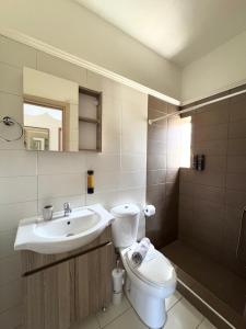 a bathroom with a sink and a toilet and a mirror at Serenity home in Souda +7 photos