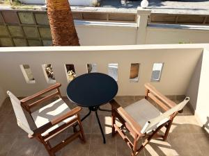 a table and two chairs on a balcony at Serenity home in Souda