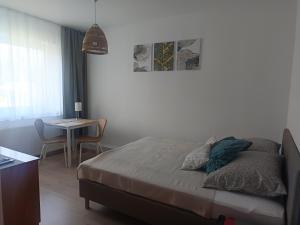 a bedroom with a bed and a table and a tableablish at Cichy Zakątek in Sianozety