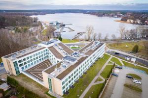 an aerial view of a building with a lake at Olsztyn Kapitańska 2 in Olsztyn