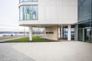 a building with a sign on the side of it at Olsztyn Kapitańska 2 in Olsztyn +4 photos