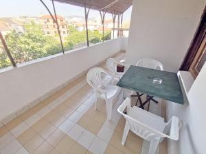 a balcony with a table and chairs and a view at Hotel VALDI in Ahtopol