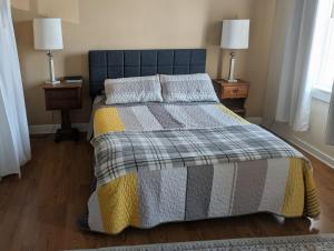 a bedroom with a bed with two night stands and two lamps at 2 bed, 1 bath riverfront loft in Salisbury