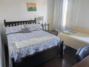a bedroom with a bed and a window at 2 bed, 1 bath riverfront loft in Salisbury +9 photos