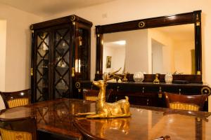 a dining room table with a gold deer statue on it at Nile Pyramidal view place in Cairo