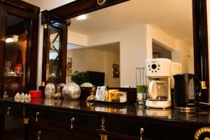 a counter with a coffee maker and a microwave on it at Nile Pyramidal view place in Cairo