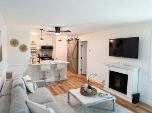 a living room with a couch and a fireplace at New Cape Cod Condo Near Beaches in Brewster