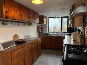 a kitchen with wooden cabinets and a counter top at Diamond View House in Letterfrack