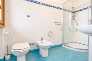 a bathroom with a toilet and a sink and a shower at Casa Aldrovandi in Capoliveri +39 photos