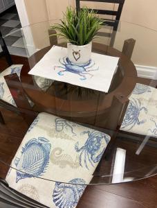 a glass table with two chairs and a plant on it at 2 bed, 1 bath riverfront loft in Salisbury