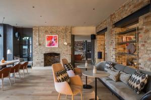 a living room with a couch and chairs and a fireplace at Zanzibar Locke in Dublin