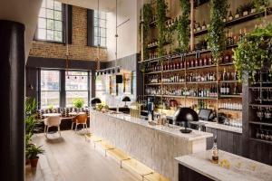 a restaurant with a bar with plants on the wall at Zanzibar Locke in Dublin