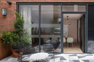 two chairs and a table in front of a building at Zanzibar Locke in Dublin +16 photos