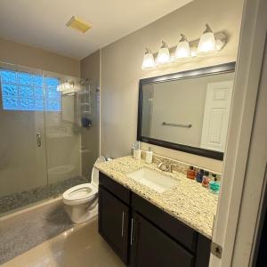 a bathroom with a sink and a toilet and a shower at Luxury and Comfort in Coconut Creek