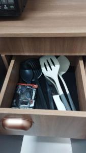 a drawer filled with utensils in a cabinet at Solar da Colina in Petrolina
