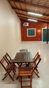 a wooden table and chairs in a room at Solar da Colina in Petrolina