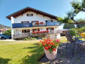 a house with flowers in front of it at Haus Lorang in Pfronten +3 photos