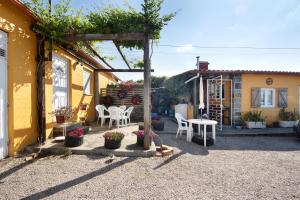 a patio of a house with a table and chairs at Romantic Room - Charming Place in Provesende