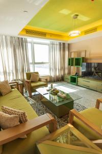 a living room with a couch and a table at Nile Suites Plaza Hotel Apartments in Cairo