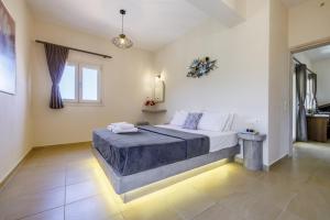 a bedroom with a large bed in a room at Villa Anatoli in Skopelos Town +49 photos