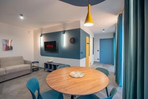 a living room with a table and chairs and a couch at Casa Matilla - Verde in La Morra