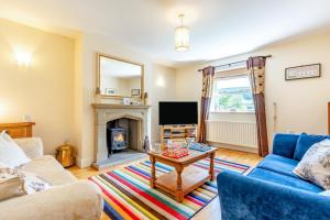 a living room with a table and a fireplace at 3 Bed in Hawes oc-ds967 in Hawes
