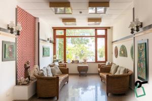 a waiting room with couches and chairs and a window at Hotiday Vieste Centro in Vieste