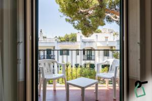 a view of a balcony with white chairs and a table at Hotiday Vieste Centro in Vieste