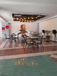a group of tables and chairs in a room at Hotel Santander Plaza in Neiva +31 photos