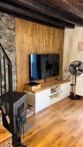 a living room with a large flat screen tv at Las Casitas de Martín in Candeleda