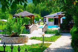 a garden with a pool and a gazebo at Lohovo Arena in Bihać
