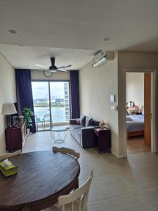 a living room with a table and a couch at Căn hộ cao cấp Diamond Island Luxury Apartment in Ho Chi Minh City +40 photos