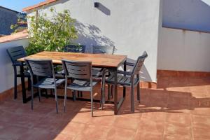 a wooden table and chairs on a patio at Casa Villamiel in Villamiel