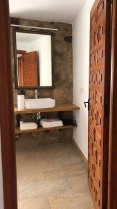 a bathroom with a sink and a mirror at Casa Villamiel in Villamiel +30 photos