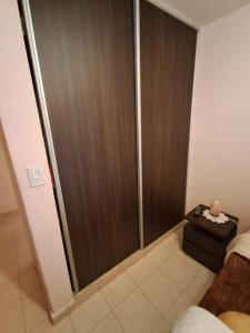 a shower with a sliding glass door in a room at Habitación Privada en La Casa de Thor in Trelew