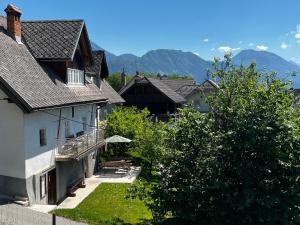 a group of houses with mountains in the background at Alpine Retreat - Lake Bled in Bled