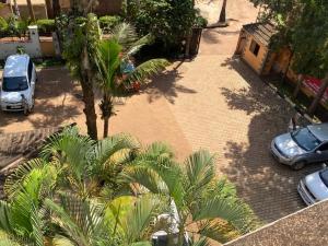an overhead view of a parking lot with cars and palm trees at Naigara hotel and suites in Kampala