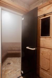 a black refrigerator in a room with a window at Hotel Tiroler Adler in Lutago